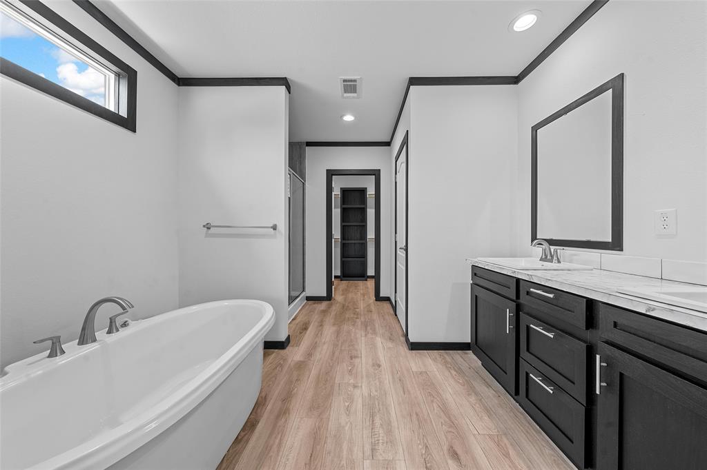 202 6th Street Mount Calm, TX 76673 - Photo 8 of 23 a bathroom with a bathtub and a sink