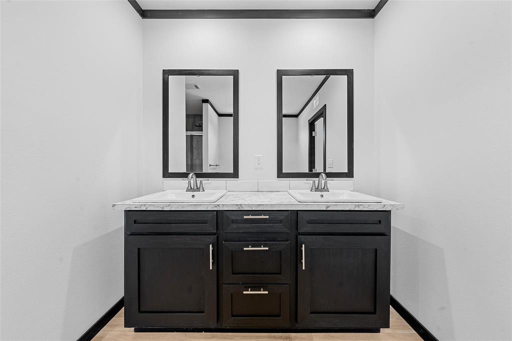 202 6th Street Mount Calm, TX 76673 - Photo 9 of 23 a bathroom with 2 sink and a mirror