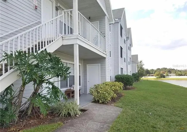 a view of a house with a yard and plants
