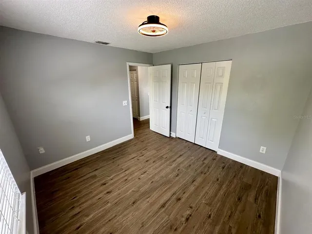 a view of a room with wooden floor