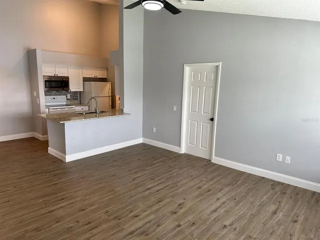 a view of a kitchen with a sink and dishwasher wooden floor