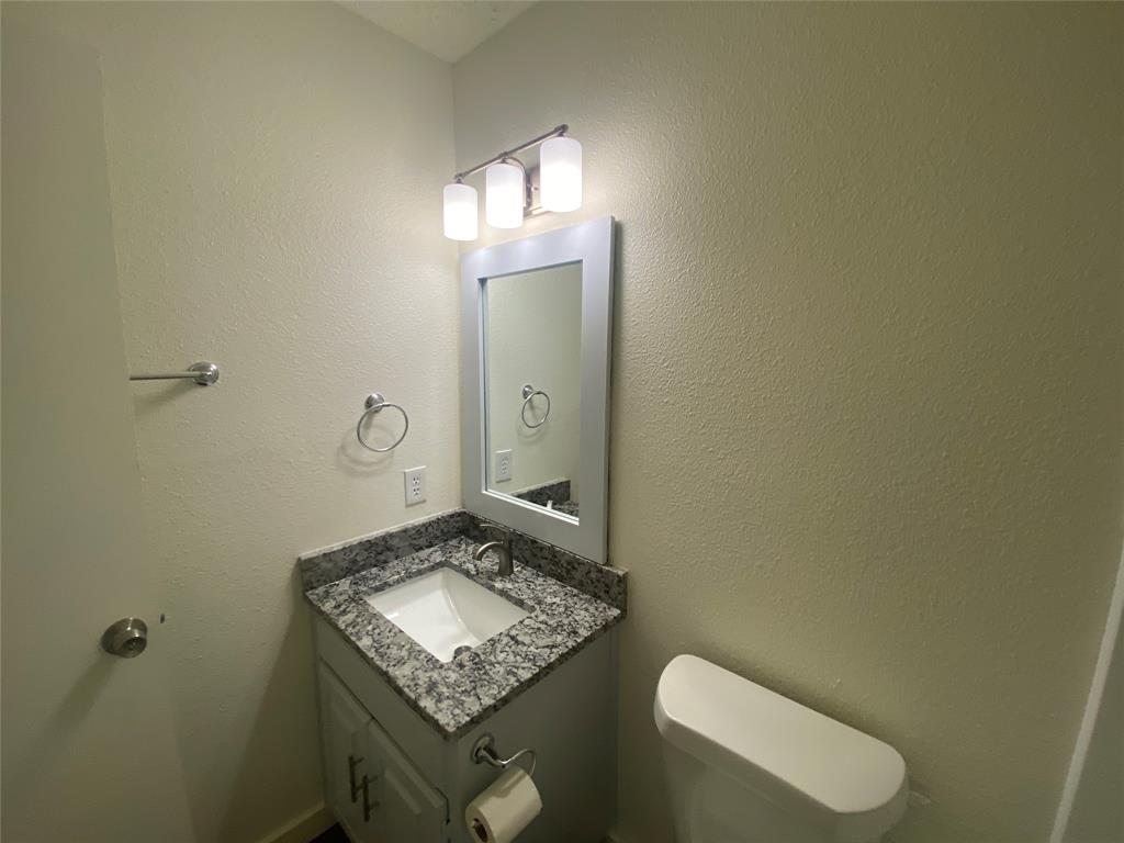 3108 Timber Ridge Point Grapevine, TX 76051 - Photo 9 of 16 a bathroom with a toilet sink and mirror