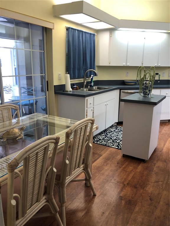 7867 Southwest 115th Loop Ocala, FL 34476 - Photo 12 of 40 a kitchen with a sink a stove cabinets and a dining table