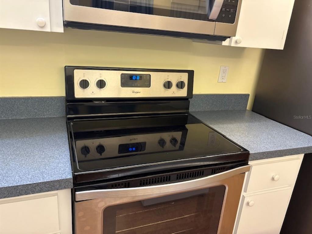 7867 Southwest 115th Loop Ocala, FL 34476 - Photo 15 of 40 a stove top oven sitting inside of a kitchen