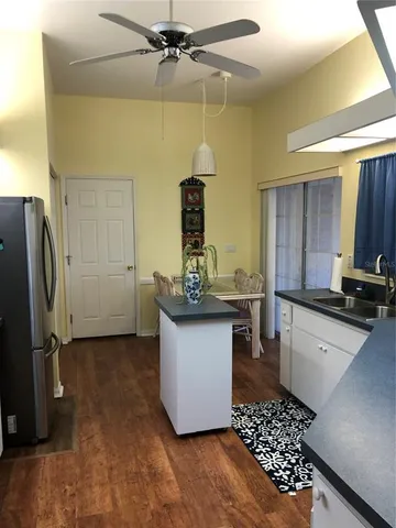 a kitchen with a sink and refrigerator