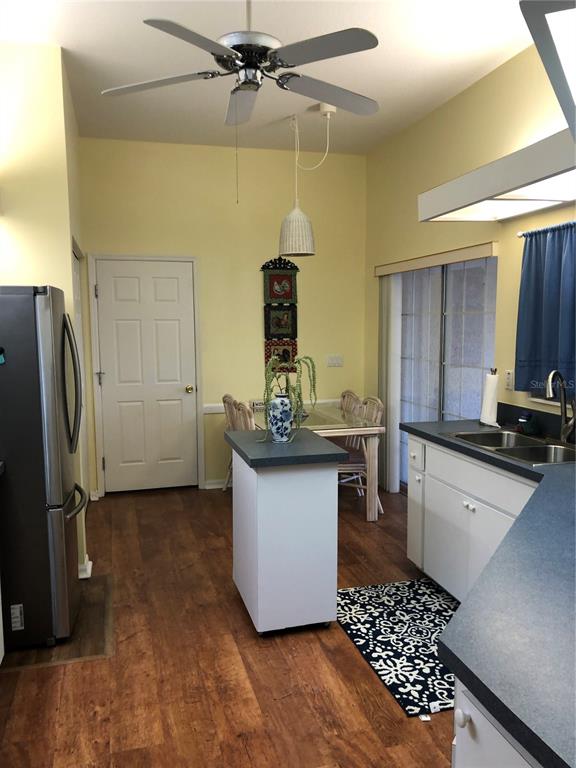 7867 Southwest 115th Loop Ocala, FL 34476 - Photo 16 of 40 a kitchen with a sink and refrigerator