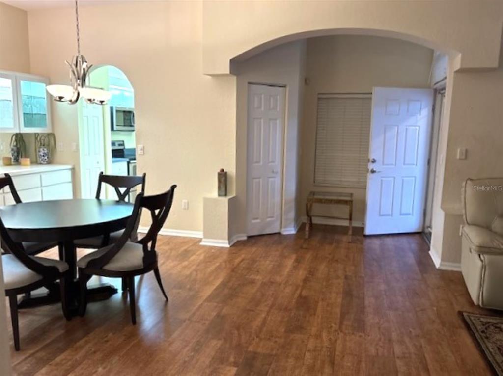 7867 Southwest 115th Loop Ocala, FL 34476 - Photo 19 of 40 a view of a dining room with furniture and wooden floor