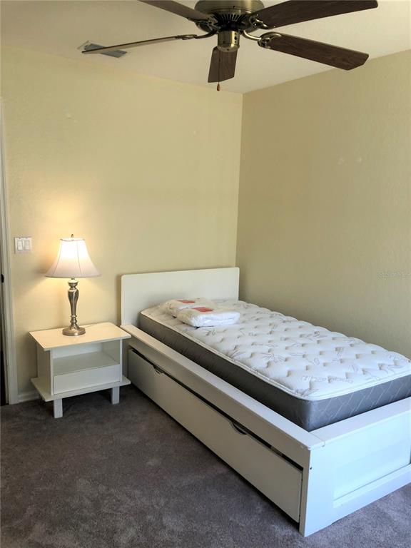 7867 Southwest 115th Loop Ocala, FL 34476 - Photo 27 of 40 a bedroom with a bed and a lamp on the dresser