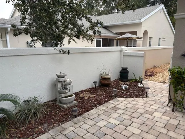 a view of a chair and table in backyard