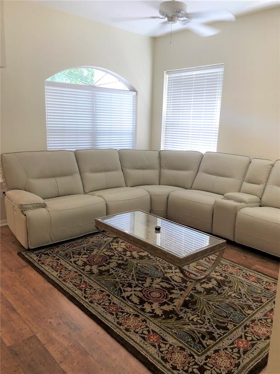 7867 Southwest 115th Loop Ocala, FL 34476 - Photo 9 of 40 a living room with furniture and a rug