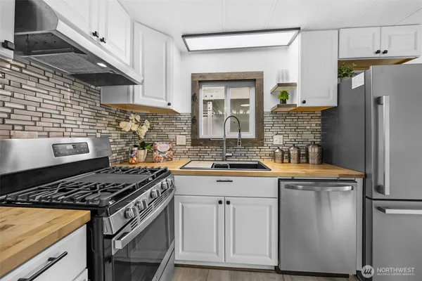 a kitchen with stainless steel appliances granite countertop a stove and a refrigerator