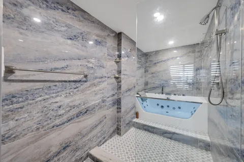 a en suite bathroom with a sink and a large mirror