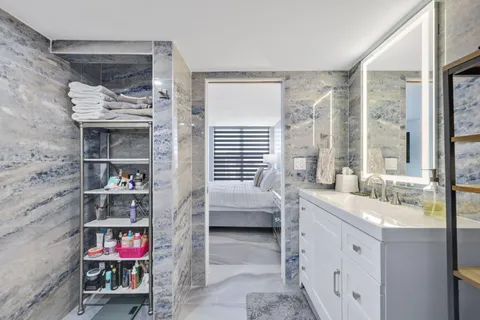 a bedroom with a bed and a desk