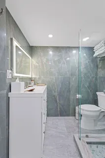 a bathroom with a sink toilet and shower