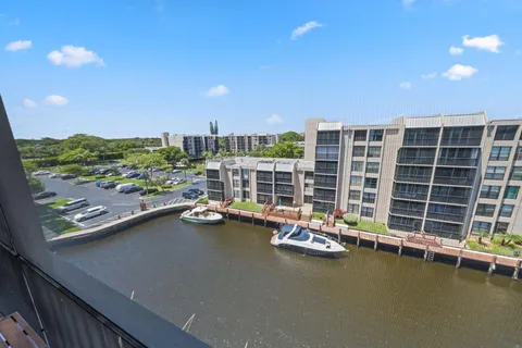 a view of a house with a yard and potted plants