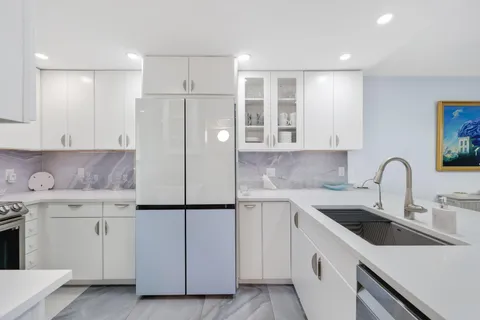 a kitchen with a sink appliances and cabinets
