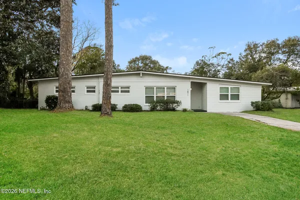 a front view of house with yard and green space