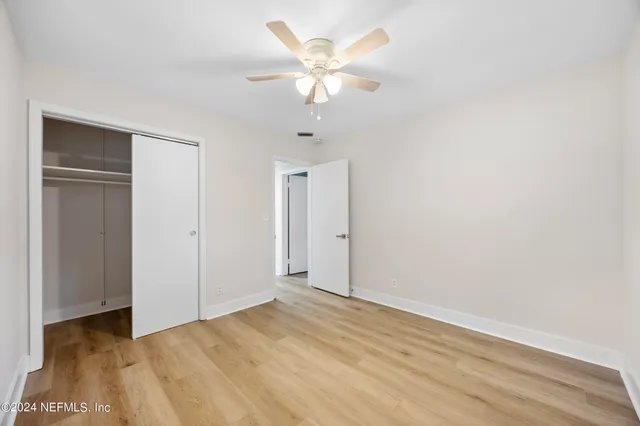 a view of an empty room with a ceiling fan