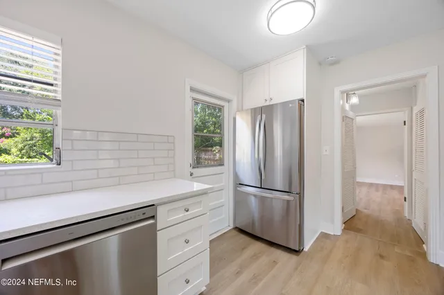 a kitchen with a refrigerator and a sink