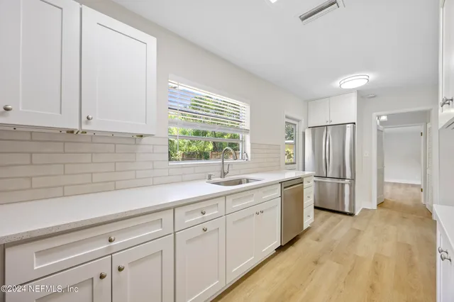 a kitchen with a sink and refrigerator