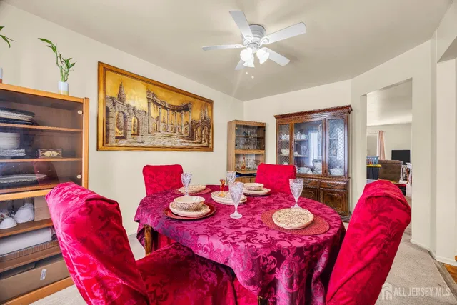 a view of a dining room with furniture and chandelier