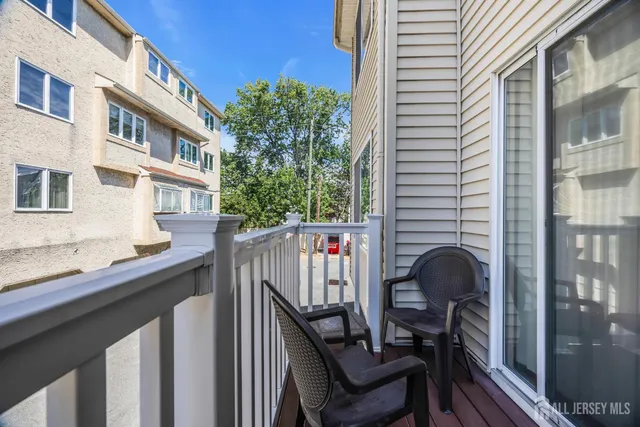 a view of a chair and table in the balcony