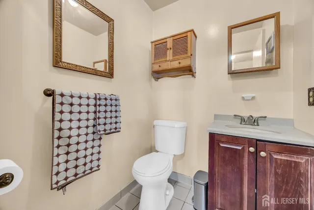 a white toilet sitting next to a bathroom sink