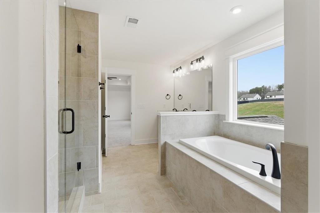 4749 Cooling Water Circle Powder Springs, GA 30127 - Photo 17 of 35 a bathroom with a tub shower and sink