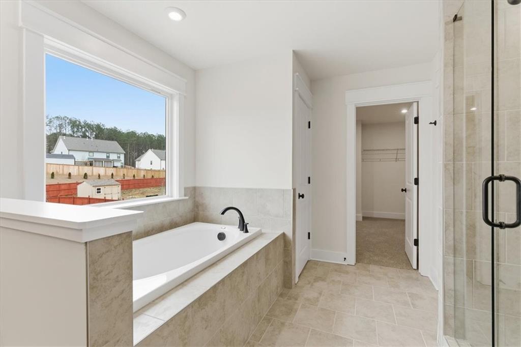 4749 Cooling Water Circle Powder Springs, GA 30127 - Photo 18 of 35 a bathroom with a bathtub and a shower