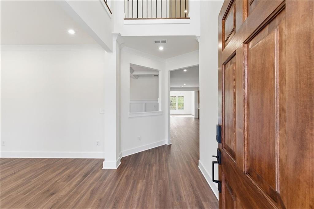 4749 Cooling Water Circle Powder Springs, GA 30127 - Photo 2 of 35 a view of a hallway with wooden floor and staircase