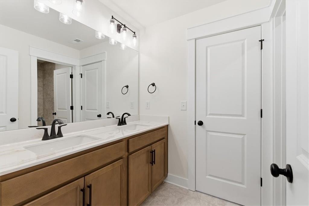4749 Cooling Water Circle Powder Springs, GA 30127 - Photo 24 of 35 a bathroom with a double vanity sink mirror and double