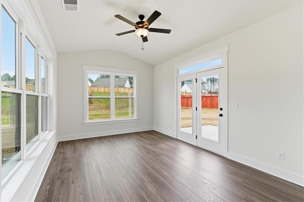 4749 Cooling Water Circle Powder Springs, GA 30127 - Photo 8 of 35 an empty room with wooden floor and windows