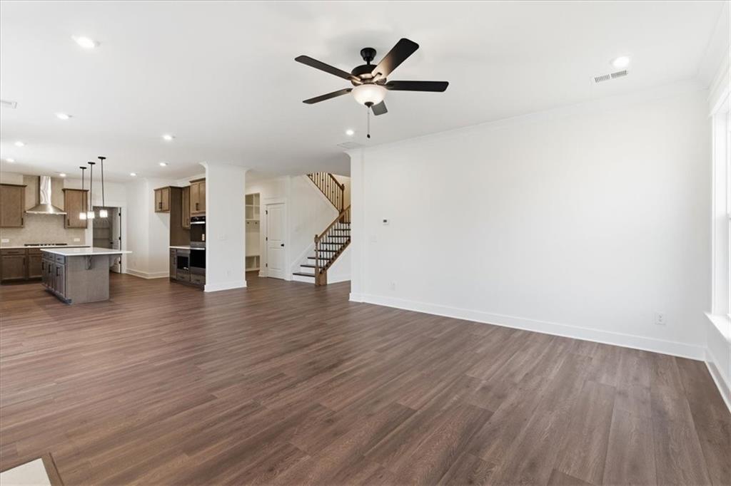4749 Cooling Water Circle Powder Springs, GA 30127 - Photo 10 of 35 an empty room with wooden floor and a ceiling fan