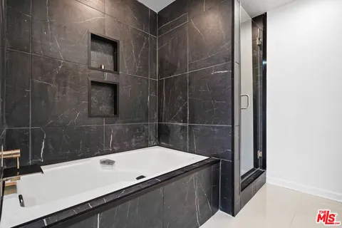 a bathroom with a bathtub and shower