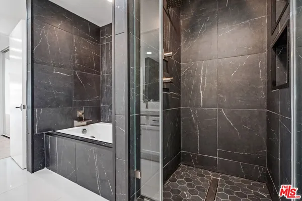 a bathroom with a shower and a sink
