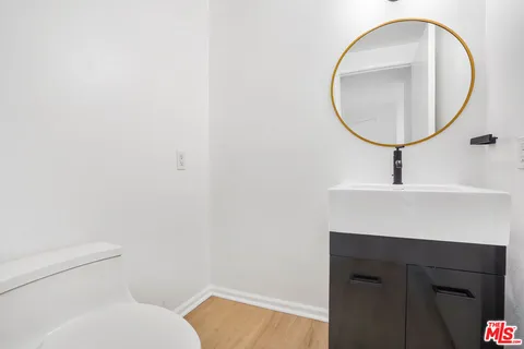 a bathroom with a sink a mirror and a toilet