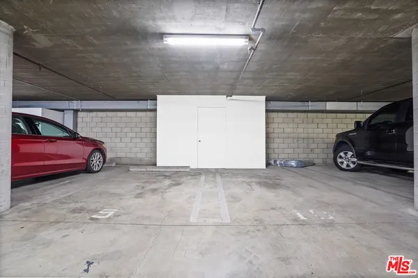 a view of garage with a parked car