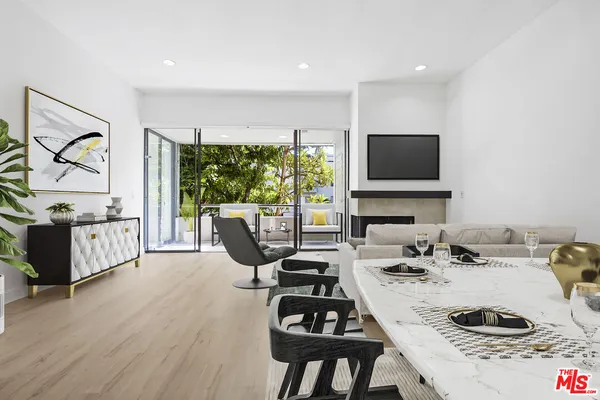 a living room with furniture a flat screen tv and a floor to ceiling window