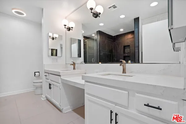 a bathroom with a sink vanity and a mirror