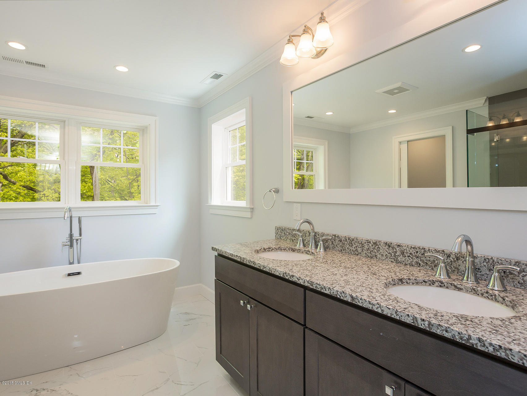 1041 Stillwater Road Stamford, CT 06902 - Photo 27 of 41 a bathroom with a granite countertop sink and a bathtub