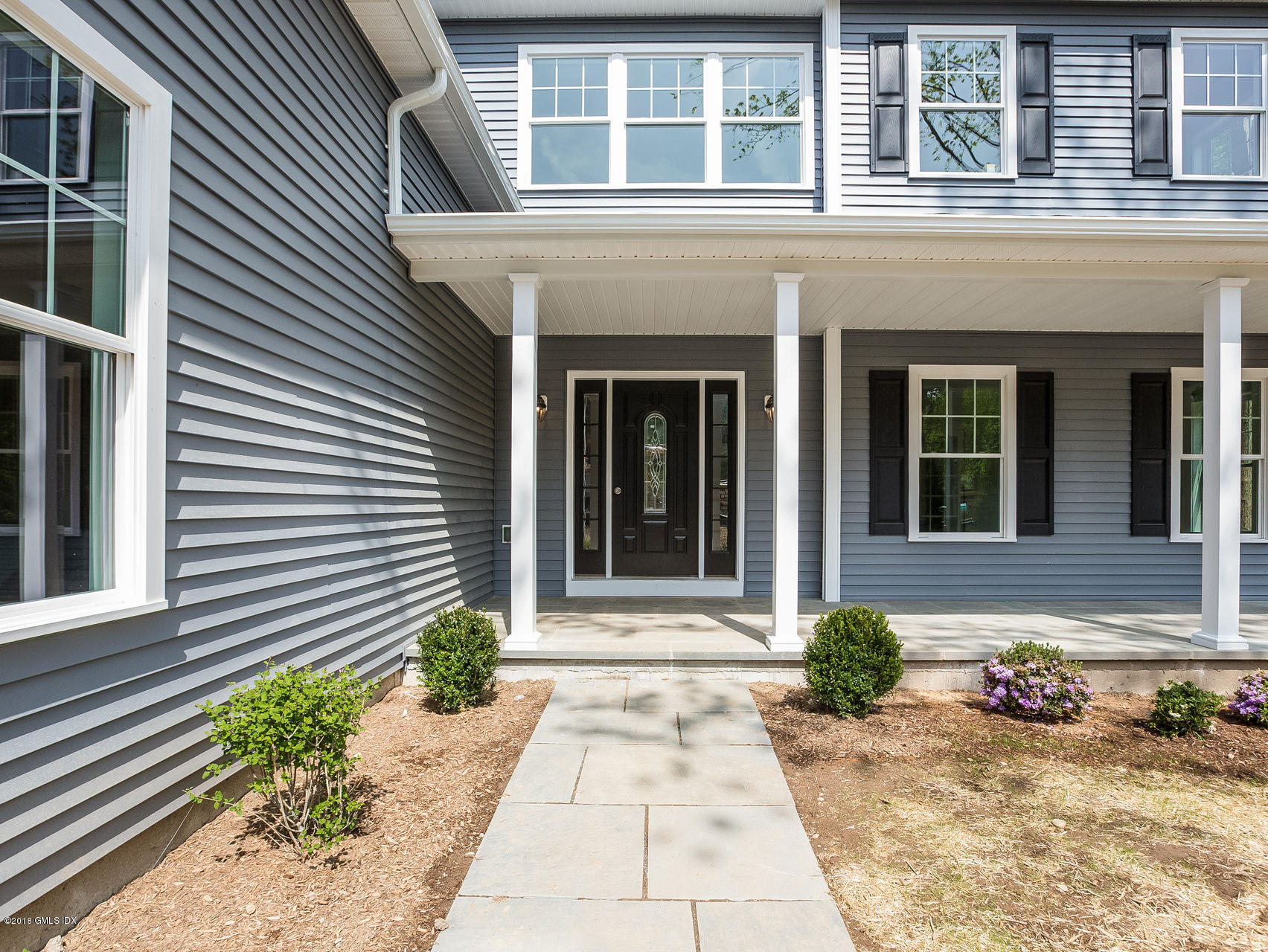 1041 Stillwater Road Stamford, CT 06902 - Photo 6 of 41 a front view of a house with a yard and potted plants