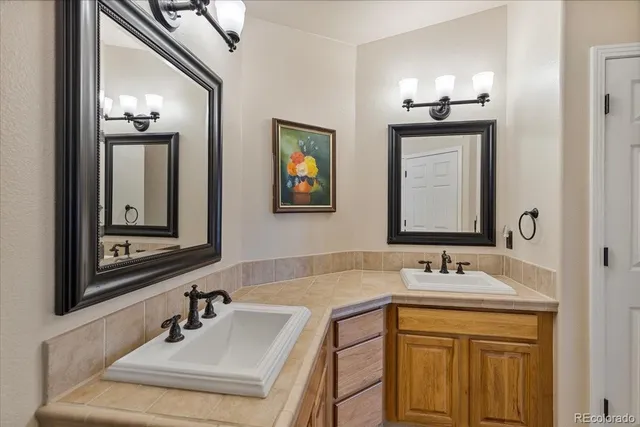 a bathroom with double vanity sinks and a mirror