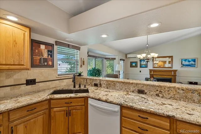 a kitchen with granite countertop a sink and a wooden floor