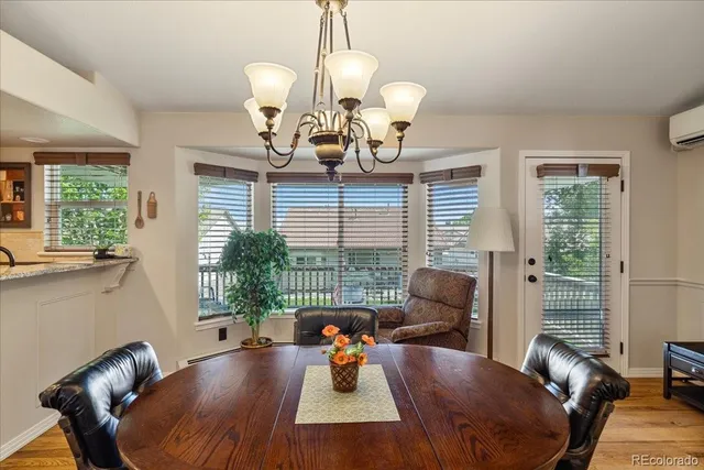 a view of a dining room with furniture wooden floor and chandelier
