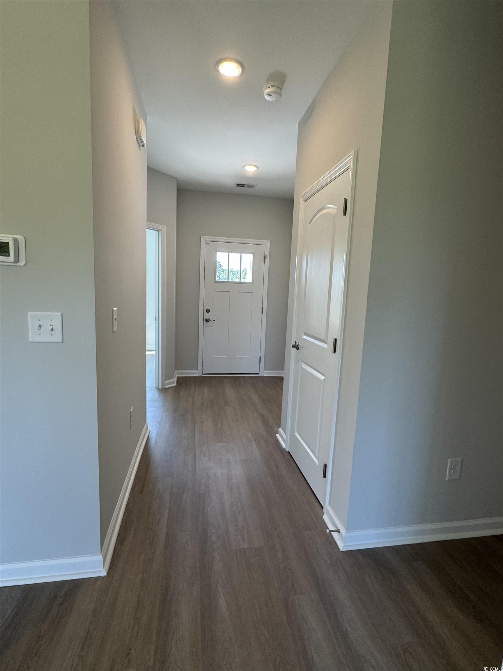 600 Shallow Cv Drive Conway, SC 29527 - Photo 11 of 14 Hall with baseboards and dark wood-style flooring