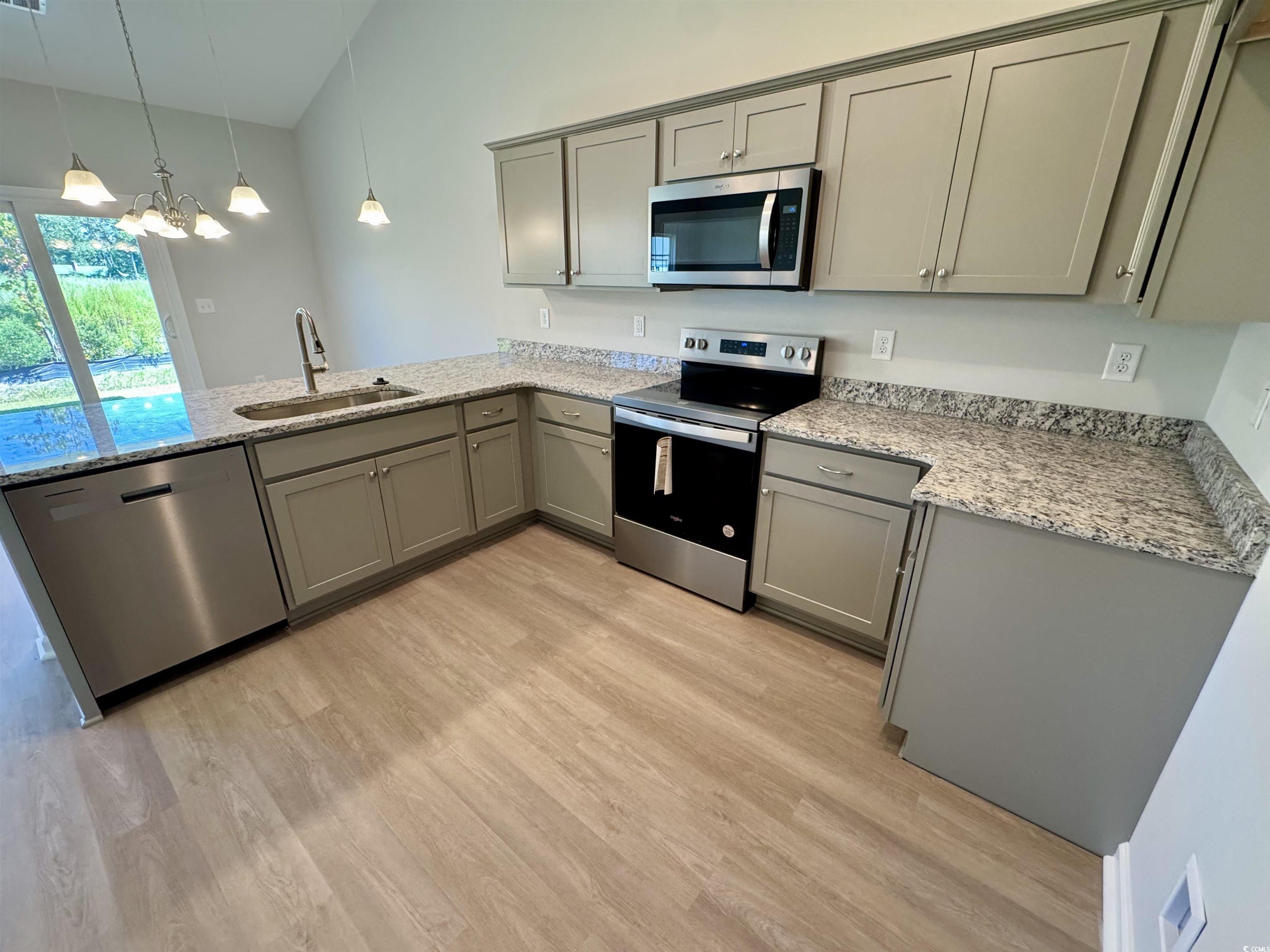 600 Shallow Cv Drive Conway, SC 29527 - Photo 2 of 14 Kitchen with gray cabinetry, appliances with stain