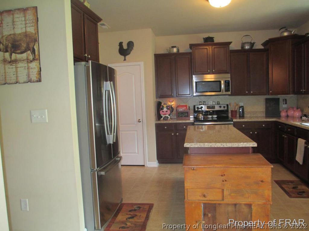 5028 Aberdeen Road Raeford, NC 28376 - Photo 21 of 34 a kitchen with refrigerator and cabinets