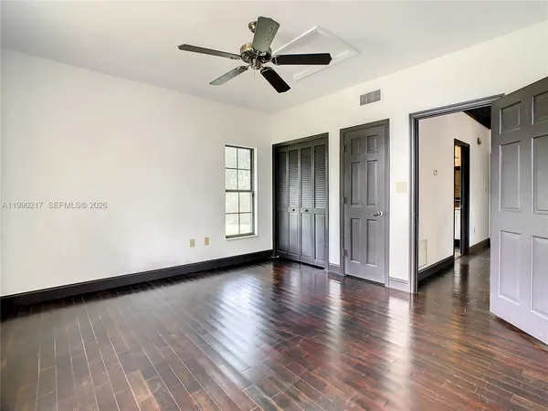 a view of a hallway with wooden floor