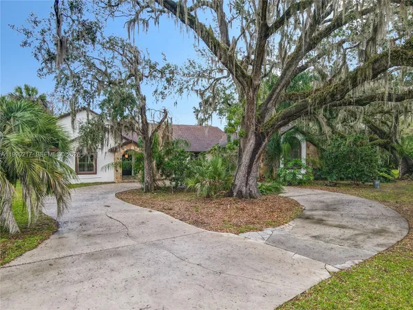 a living room with fireplace furniture and a wooden floor