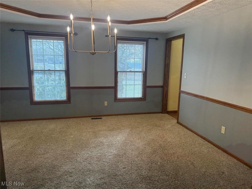 3530 State Road Medina, OH 44256 - Photo 10 of 47 Carpeted dining room featuring a healthy amount of sunlight and a textured ceiling